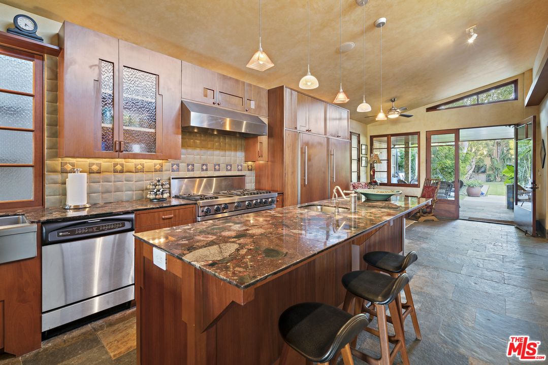 23746 Malibu Road Malibu, CA 90265 - Photo 18 of 46 a kitchen with a sink a counter and chairs