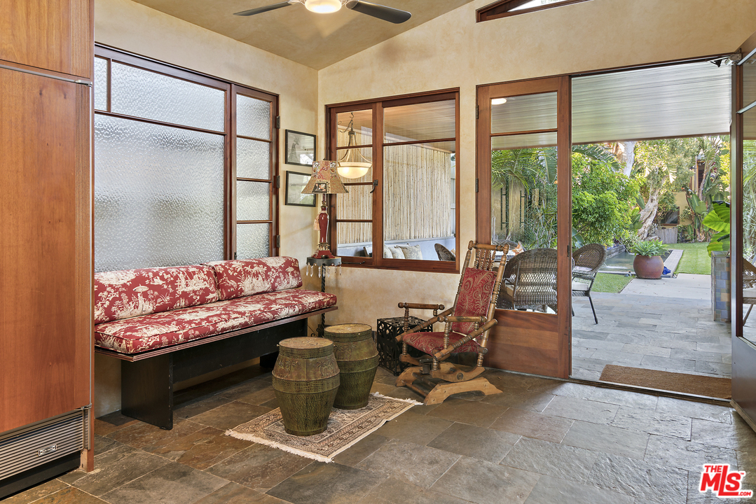 23746 Malibu Road Malibu, CA 90265 - Photo 19 of 46 a living room with furniture a rug and a floor to ceiling window