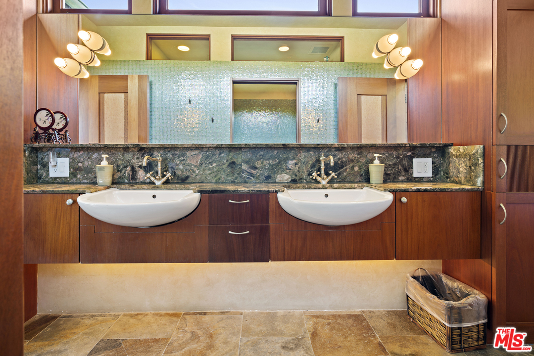 23746 Malibu Road Malibu, CA 90265 - Photo 21 of 46 a bathroom with a sink and a mirror