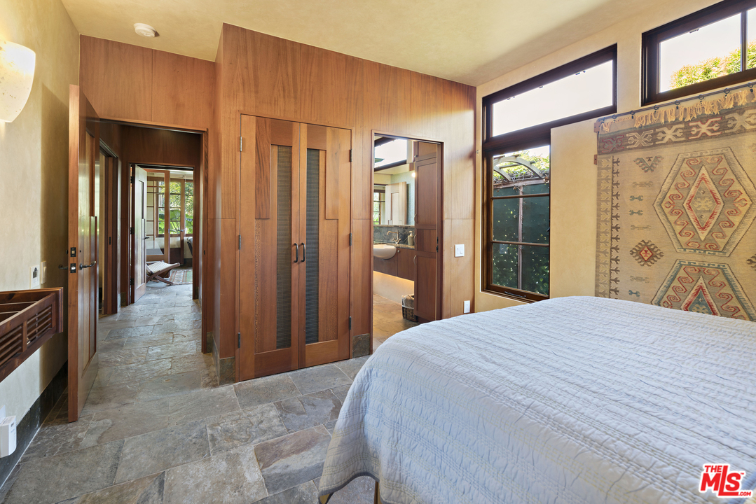 23746 Malibu Road Malibu, CA 90265 - Photo 23 of 46 a bedroom with a large bed and a large window