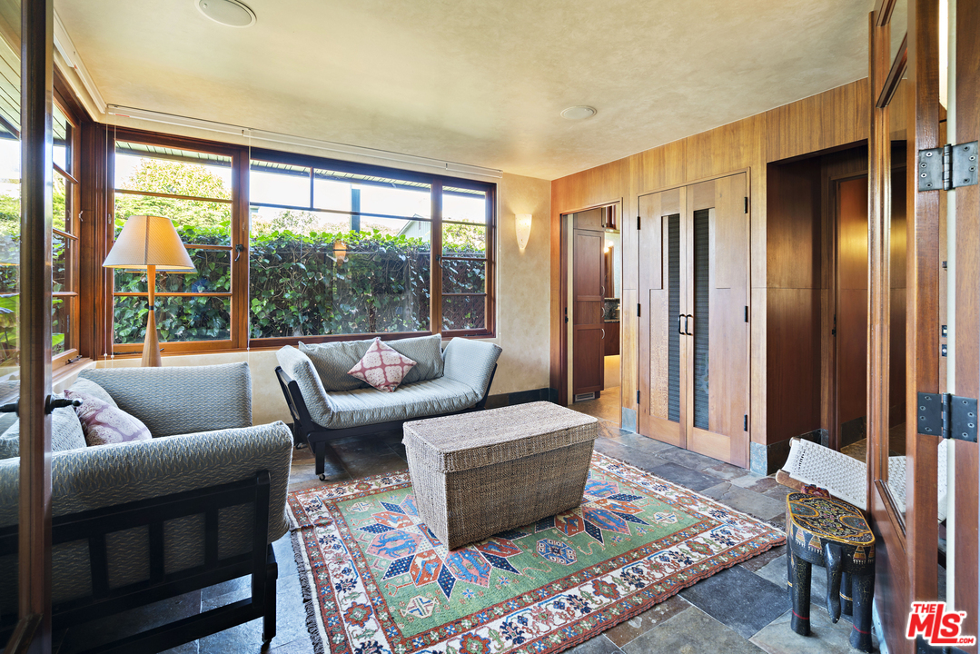 23746 Malibu Road Malibu, CA 90265 - Photo 24 of 46 a living room with furniture and a floor to ceiling window