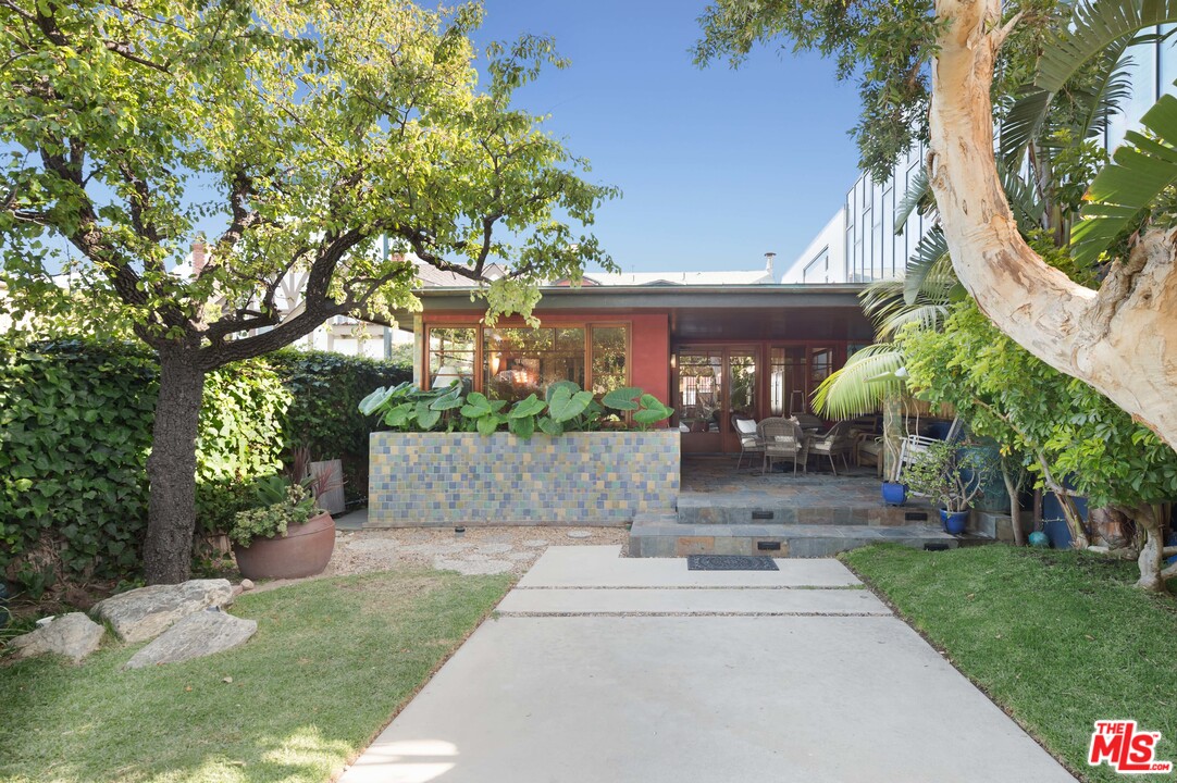 23746 Malibu Road Malibu, CA 90265 - Photo 28 of 46 a front view of a house with a yard and potted plants