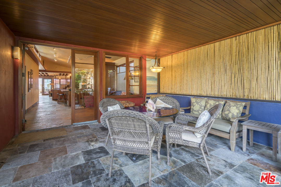 23746 Malibu Road Malibu, CA 90265 - Photo 30 of 46 a dining room with furniture and wooden floor