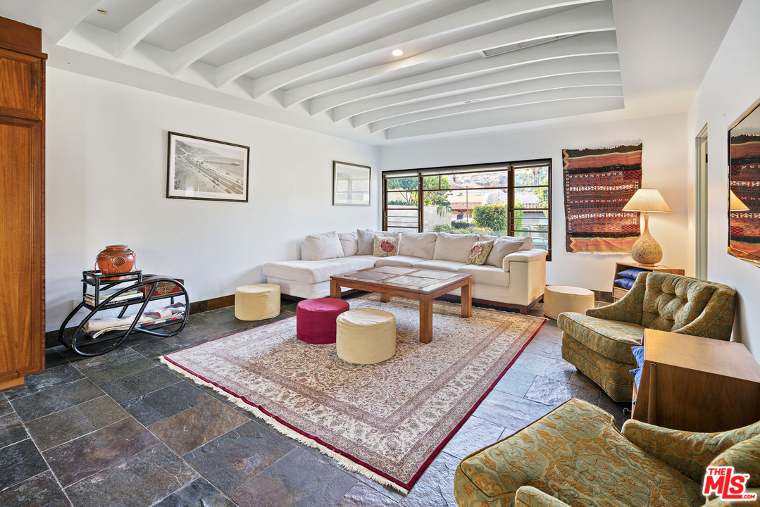 23746 Malibu Road Malibu, CA 90265 - Photo 35 of 46 a living room with furniture a large window and a rug