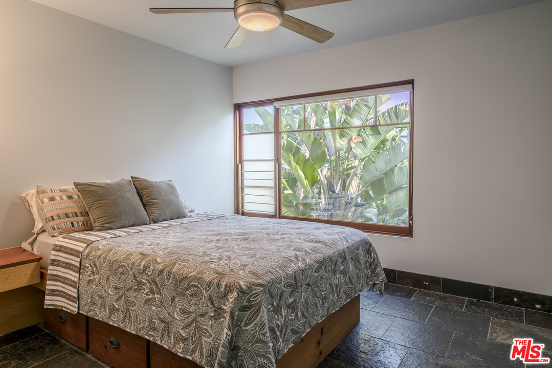 23746 Malibu Road Malibu, CA 90265 - Photo 43 of 46 a bed sitting in a bedroom next to a window