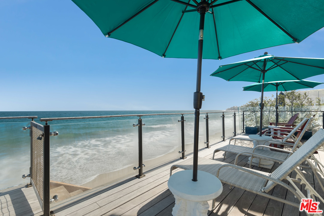 23746 Malibu Road Malibu, CA 90265 - Photo 6 of 46 a view of table and chairs under an umbrella
