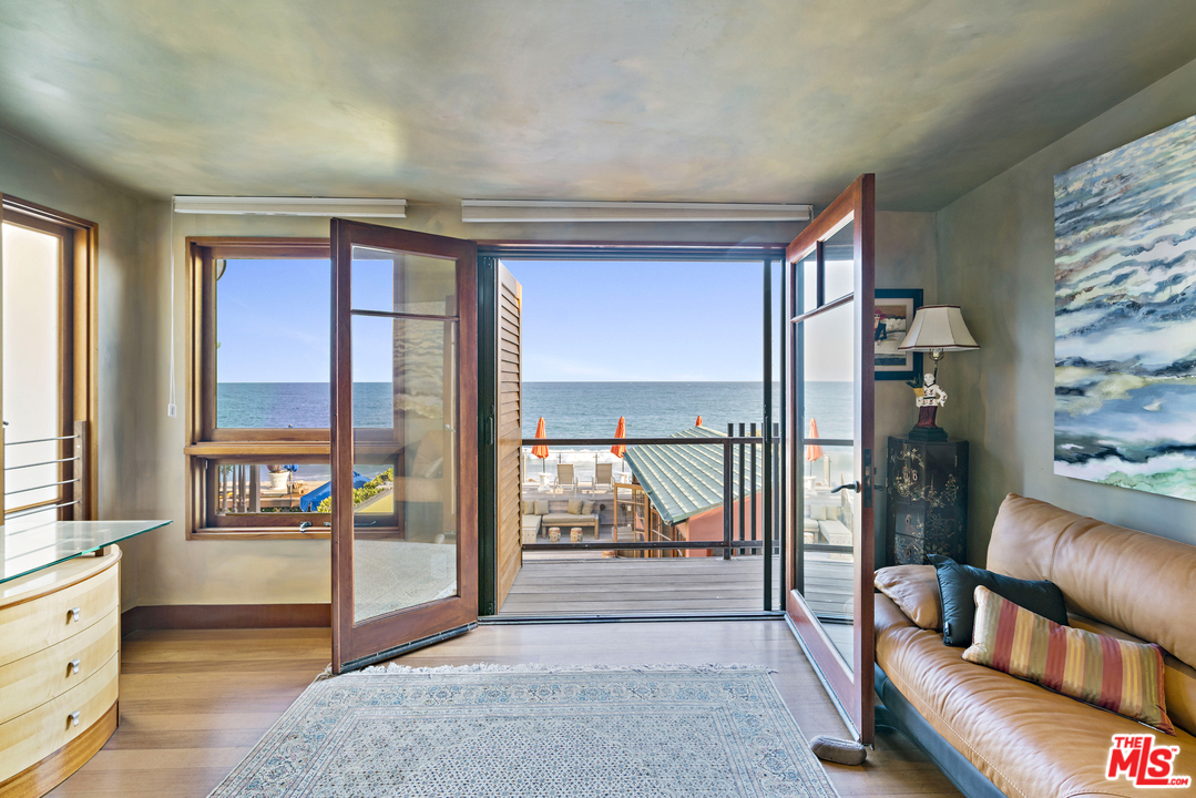 23746 Malibu Road Malibu, CA 90265 - Photo 10 of 46 a living room with furniture and a floor to ceiling window
