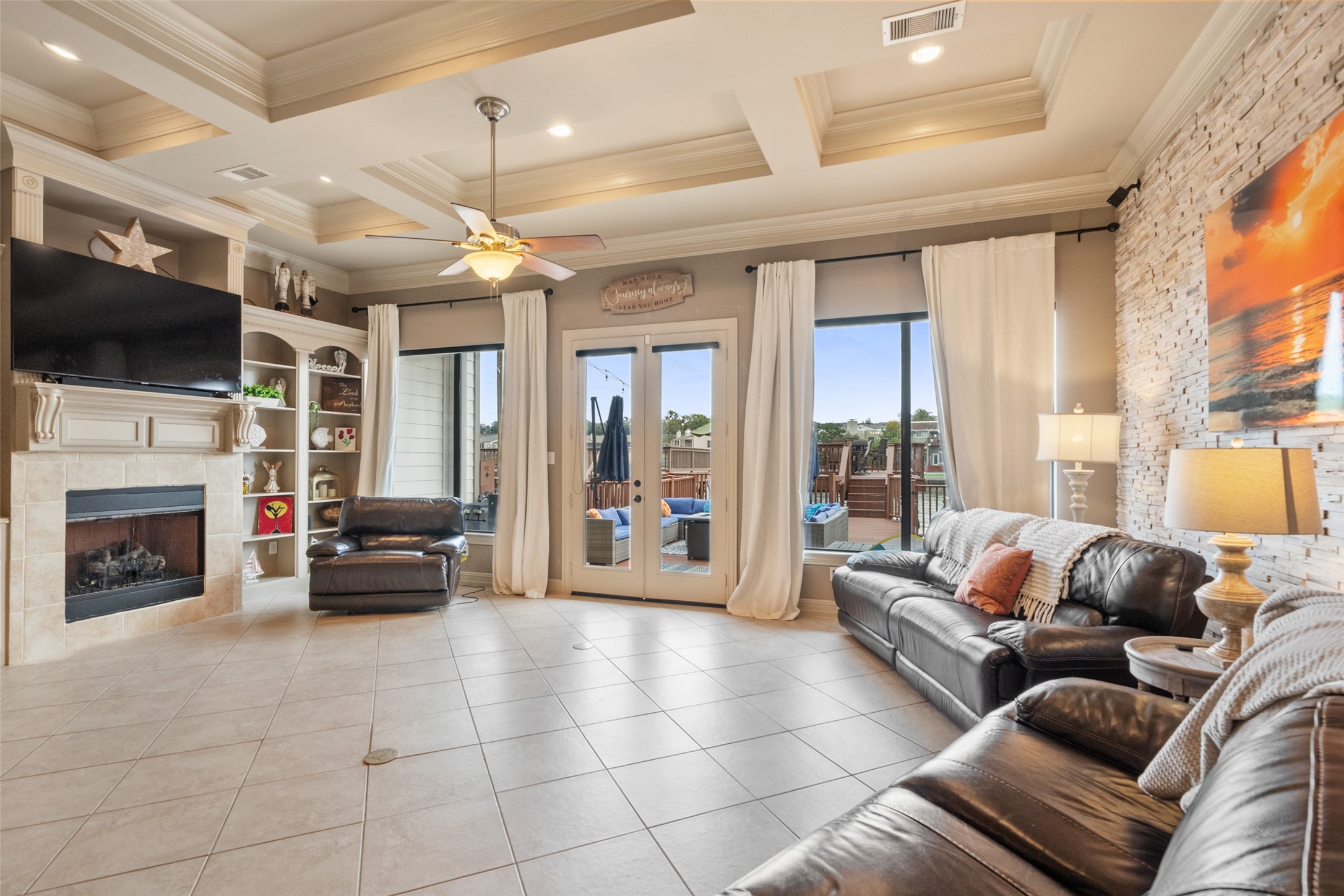 255 Capetown Way Conroe, TX 77356 - Photo 5 of 30 a living room with furniture a fireplace and a flat screen tv