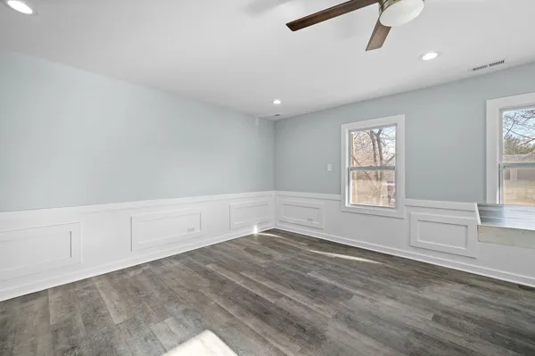 wooden floor in an empty room with a window
