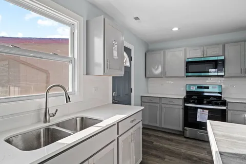 a close view of a kitchen sink and a stove