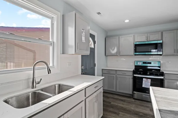 a close view of a kitchen sink and a stove