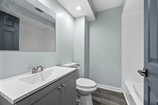 a bathroom with a sink toilet and a mirror