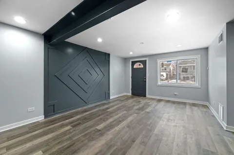 a view of kitchen with refrigerator and window