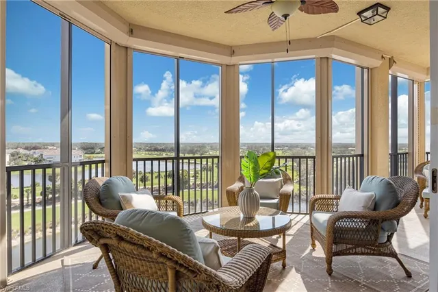 a living room with furniture and a floor to ceiling window