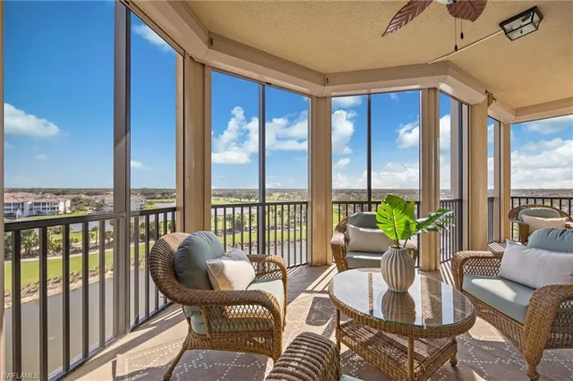 a balcony with furniture and floor to ceiling window