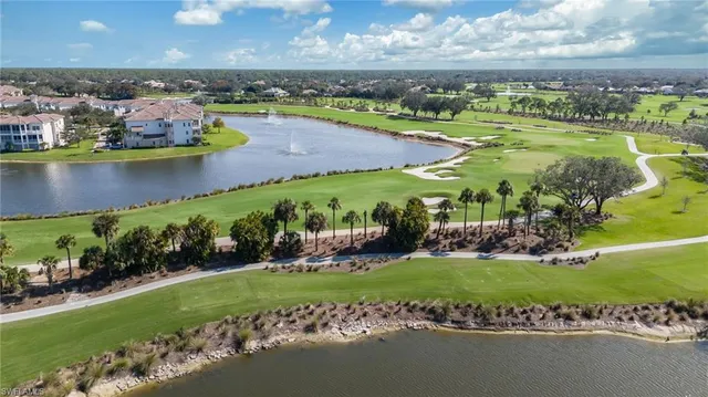 an aerial view of a city with lots of residential buildings lake and ocean view