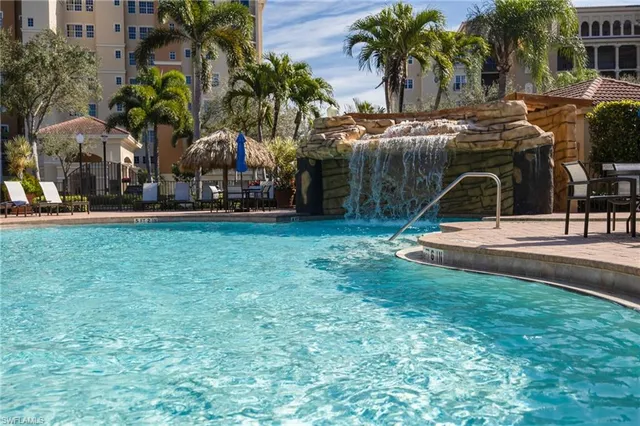 a view of a patio with table and chairs under an umbrella