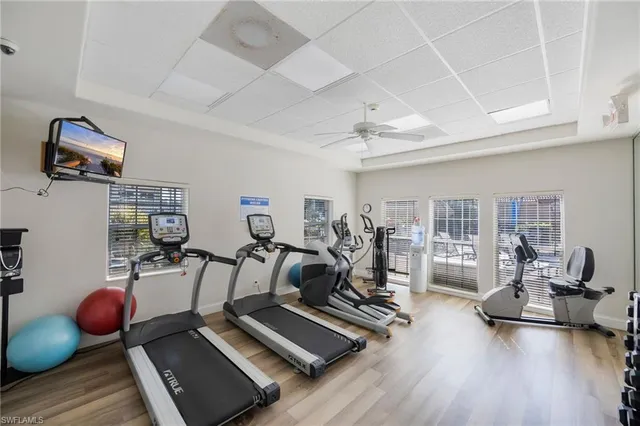 a living room with furniture kitchen view and a large window