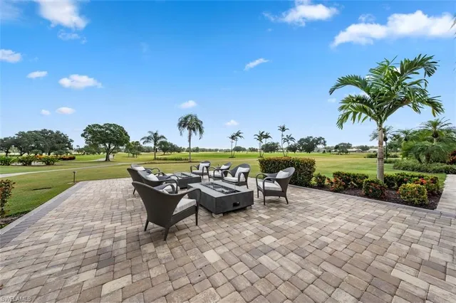 a view of a room with gym equipment and large windows