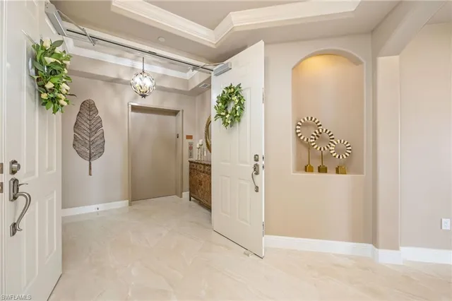 a view of a hallway with entryway and window