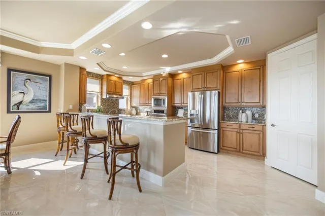 a kitchen with a refrigerator and a dining table