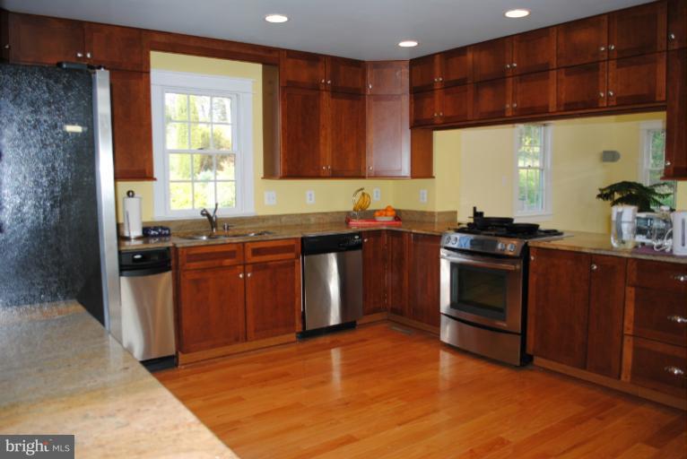 77 Forest Grove Road Amissville, VA 20106 - Photo 14 of 30 a kitchen with stainless steel appliances granite countertop a sink a stove a refrigerator and island