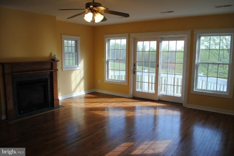 77 Forest Grove Road Amissville, VA 20106 - Photo 4 of 30 a view of an empty room with wooden floor and a window