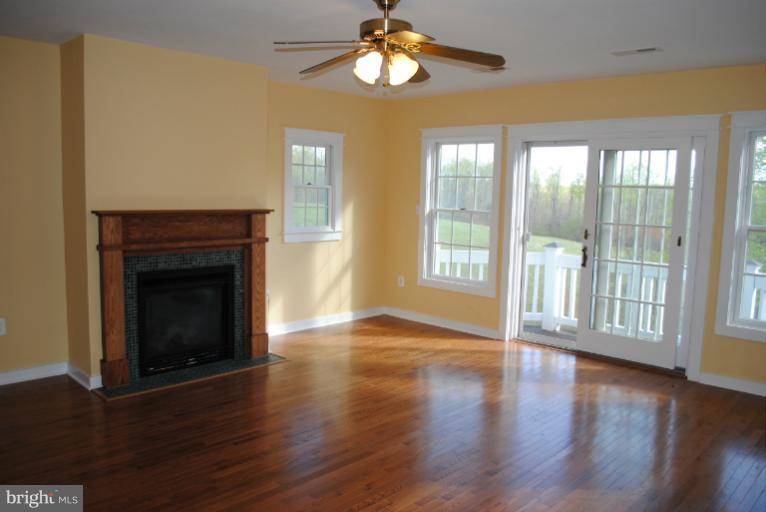 77 Forest Grove Road Amissville, VA 20106 - Photo 6 of 30 a view of an empty room with wooden floor and a window