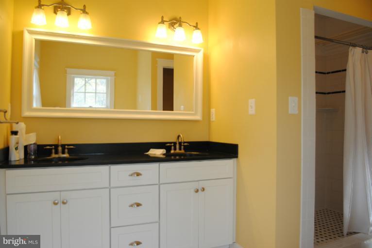 77 Forest Grove Road Amissville, VA 20106 - Photo 10 of 30 a bathroom with a granite countertop sink and a mirror