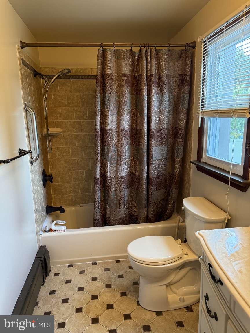 1839 Byberry Road Bensalem, PA 19020 - Photo 15 of 24 a bathroom with a sink a toilet a mirror and shower