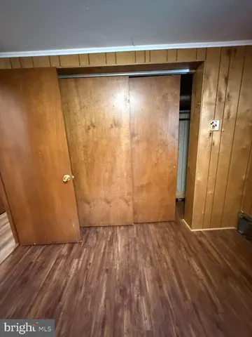 a view of a room with wooden floor and bench