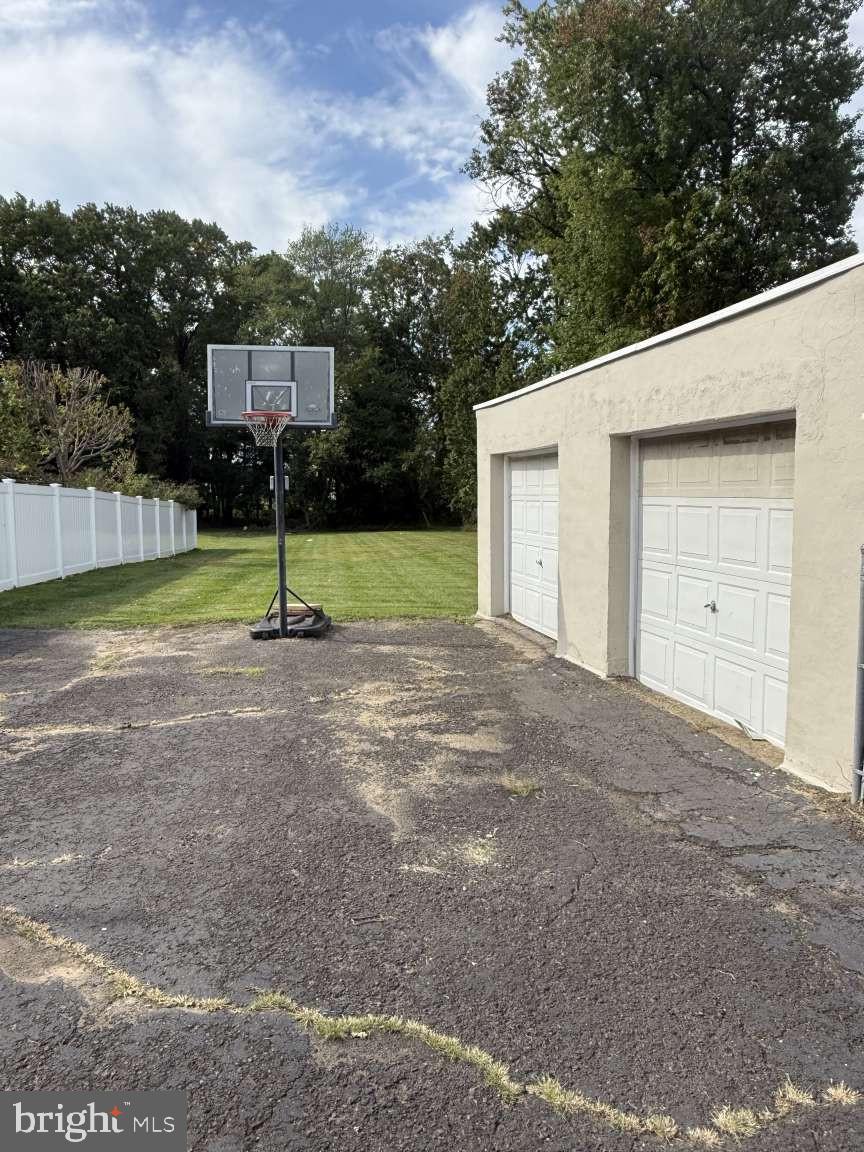 1839 Byberry Road Bensalem, PA 19020 - Photo 7 of 24 a backyard of a house with a slide and swing