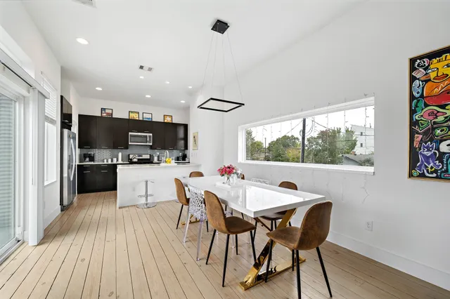 a view of a dining room with furniture window and wooden floor