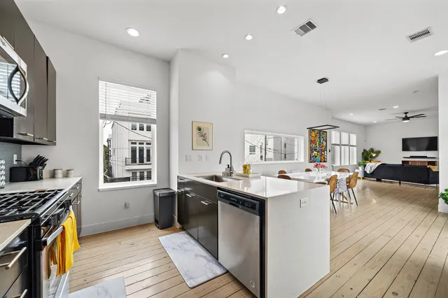 a kitchen with granite countertop a sink stove and cabinets