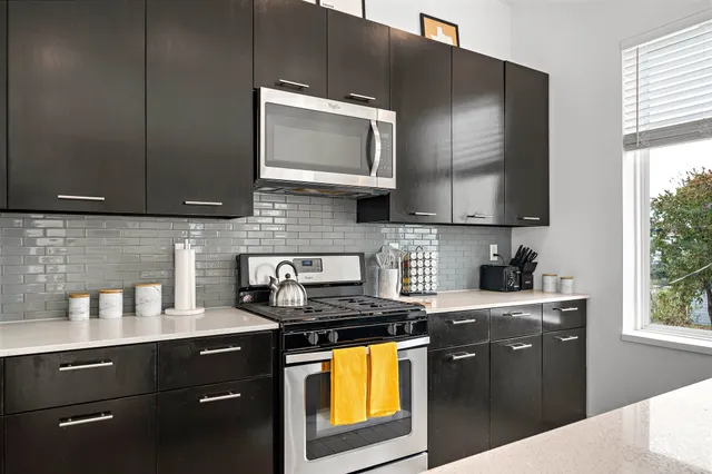 a kitchen with a sink a stove and microwave