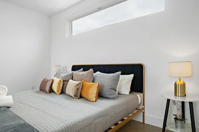 a bedroom with a bed and a lamp on table