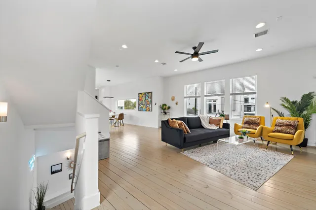 a living room with furniture and a wooden floor