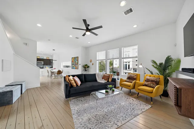a living room with furniture and wooden floor