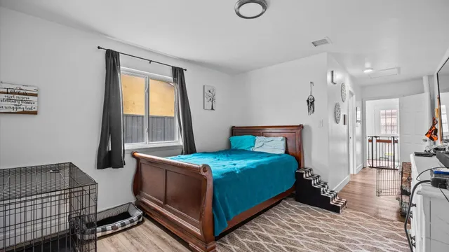 a bedroom with a bed and a window