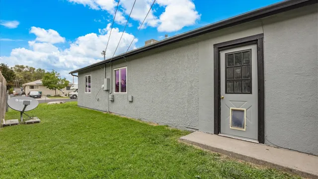 a backyard of a house with table and chairs