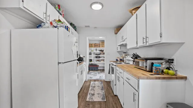 a kitchen with stainless steel appliances granite countertop a refrigerator and a stove