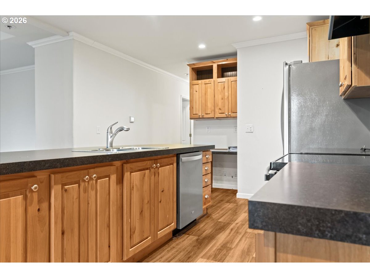 7136 South King Street Canby, OR 97013 - Photo 15 of 31 a kitchen with a refrigerator and a sink