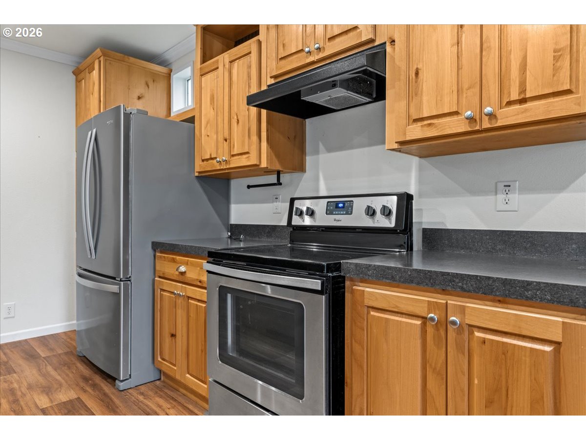 7136 South King Street Canby, OR 97013 - Photo 16 of 31 a kitchen with stainless steel appliances granite countertop a refrigerator stove and cabinets