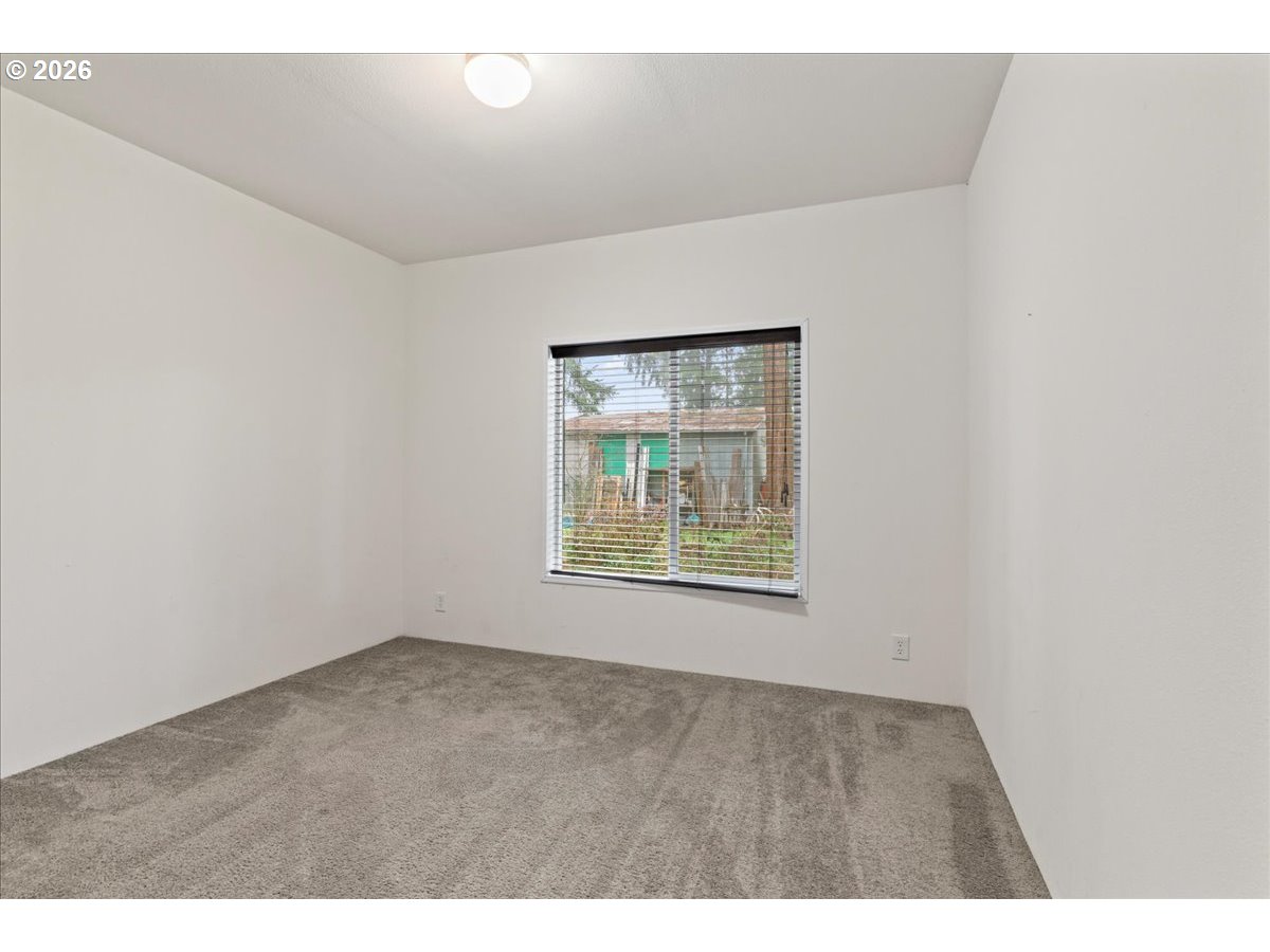7136 South King Street Canby, OR 97013 - Photo 22 of 31 a view of an empty room with a window