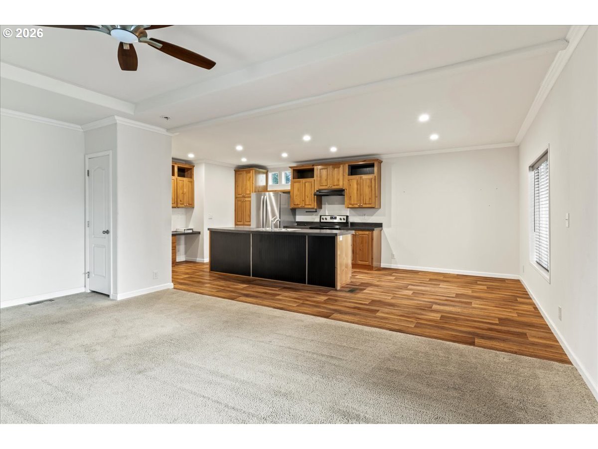 7136 South King Street Canby, OR 97013 - Photo 8 of 31 a view of kitchen and empty room with wooden floor