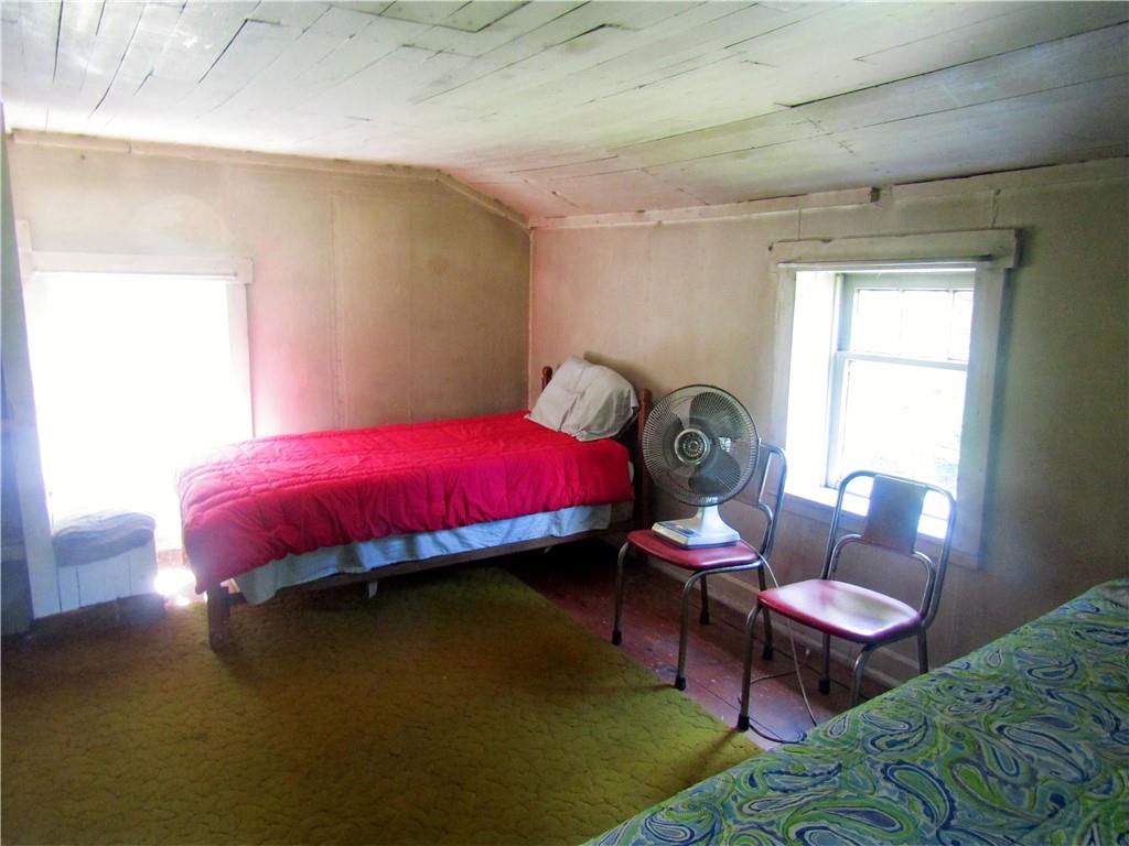 457 Grasser Road Manns Choice, PA 15550 - Photo 32 of 36 a bed room with a bed and a chair