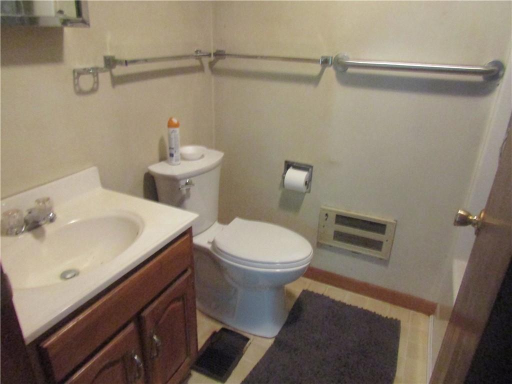 457 Grasser Road Manns Choice, PA 15550 - Photo 34 of 36 a white toilet sitting next to a bathroom sink