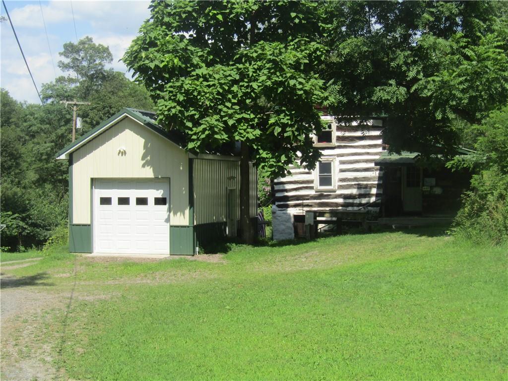 457 Grasser Road Manns Choice, PA 15550 - Photo 5 of 36 a front view of a house with a yard and a garage