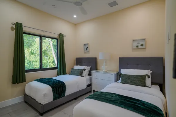 a bedroom with a bed and a large window