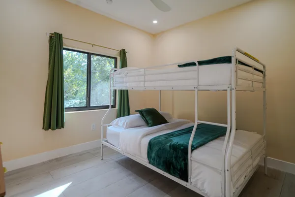 a bedroom with a bed and a window